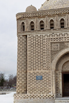 Ismail Samani Mausoleum in Bukhara featuring intricate decorative brickwork and arched entrance. Ancient Islamic monument in Uzbekistan, ideal for travel guides and cultural heritage publications.