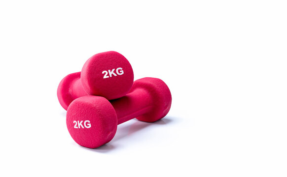 Red neoprene weight training dumbbells isolated on white background, versatile fitness equipment for home gyms, resistance exercise, body sculpting and improving strength, endurance and performance.