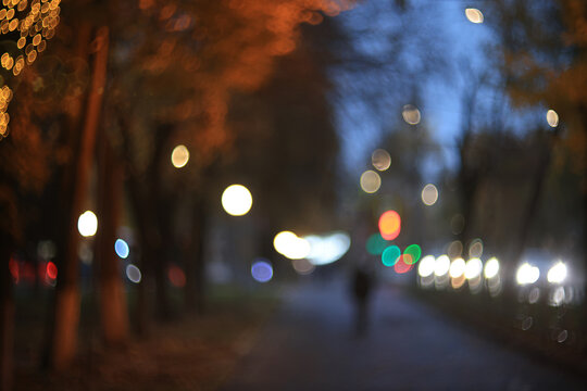 Evening in an autumn park, abstract blurred background, changing seasons in the city