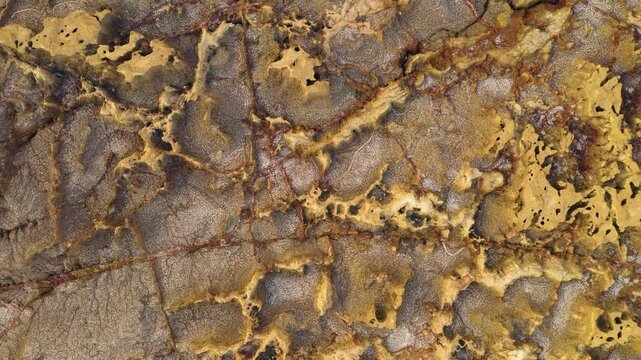 Aerial view of the colorful geothermal landscape in the Danakil Depression with mineral deposits and volcanic salt formations in Dalol, Afar, Ethiopia.