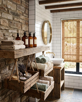 Rustic bathroom with floating shelf, rope-suspended crates, and reclaimed wood.