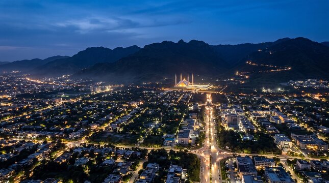 islamabad pakistan faisal mosque aerial view cityscape night dusk twilight capital city urban architecture landmark mosque lights illuminated mountains margalla hills hills scenic