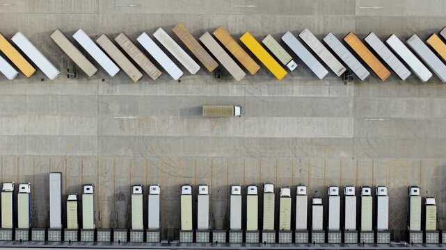 Top-Down Aerial View of Semi-Trailers and HGVs Parked at Logistics Warehouse
