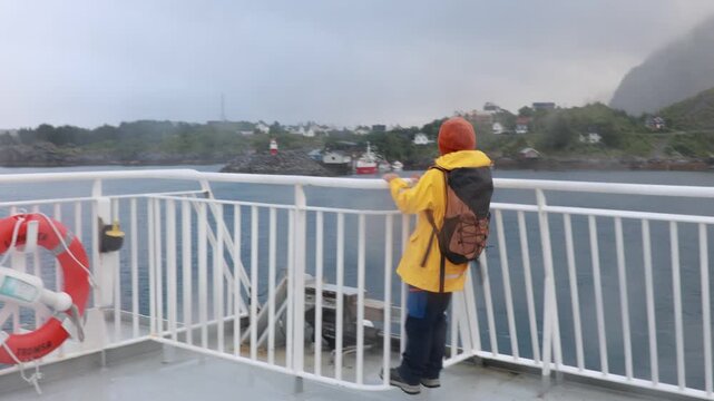 People, enjoying ferry ride between Bodo and Lofoten Moskenesoya summertime, child and adults on a ferry on sunset
