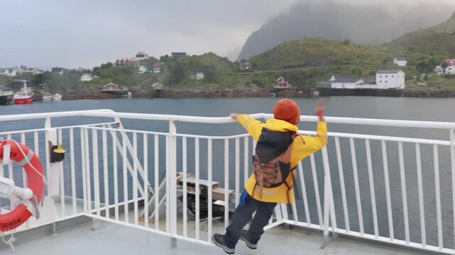 People, enjoying ferry ride between Bodo and Lofoten Moskenesoya summertime, child and adults on a ferry on sunset