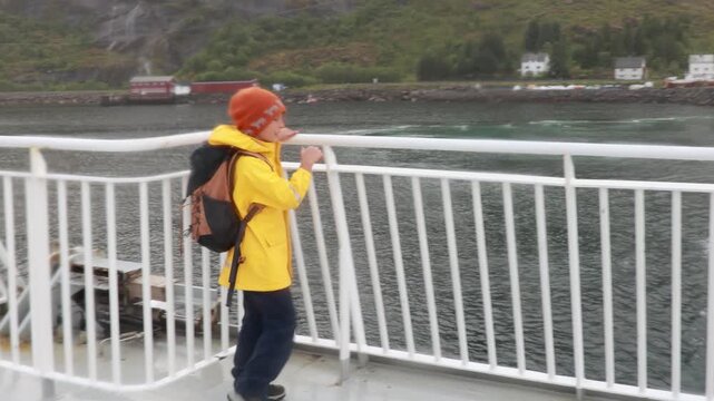 People, enjoying ferry ride between Bodo and Lofoten Moskenesoya summertime, child and adults on a ferry on sunset