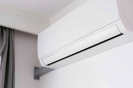 Modern white split air conditioner unit mounted on minimalist indoor wall for cooling efficiency