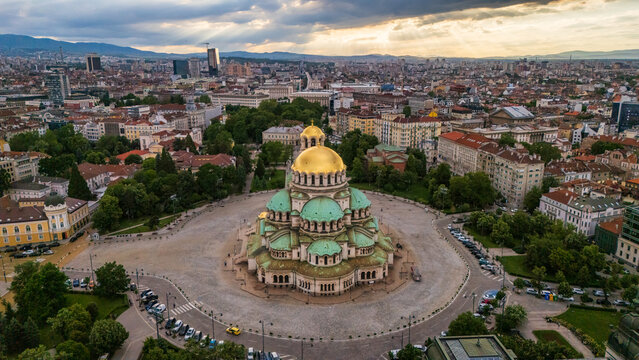 Aerial view of the Alexander Nevsky Cathedral with its golden domes and green roofs surrounded by the historic city center of Sofia, Sofia City Province, Bulgaria.
