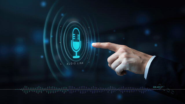 A business person touching a digital audio interface with a glowing microphone icon on a dark background with jacket interacts holographic hand suit