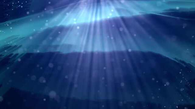 Underwater light rays filtering down through blue water with floating particles loop