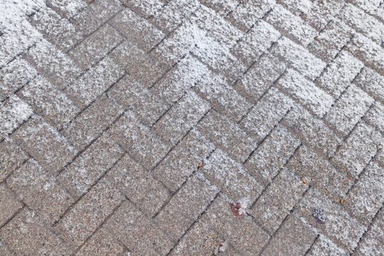 Winter texture of paving slabs covered with snow, top view, background surface in snow