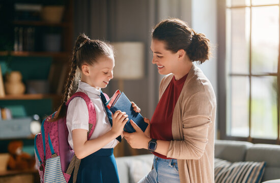 Happy Mother Helping Daughter Get Ready for School Morning Routine