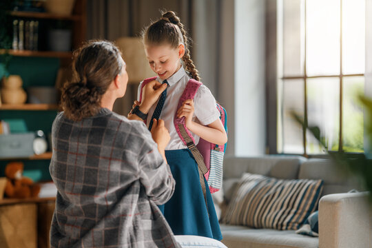 Mother Helping Daughter Get Ready for School Morning Routine