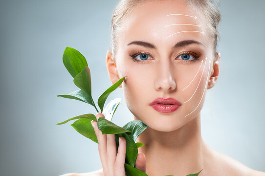 Beautiful Woman with Perfect Skin and Green Leaves Promoting Natural Skincare