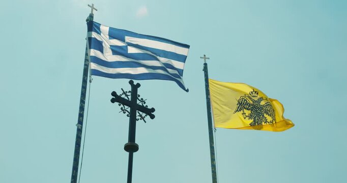 Greece national flag and Greek Orthodox Church flag waving in the wind
