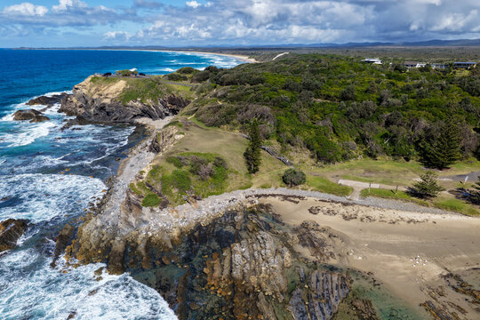 Aerial view of clear turquoise ocean water and rugged rocky coastline at Brooms Head, showcasing the natural coastal landscape and distinctive rock formations along the Clarence Valley coastline