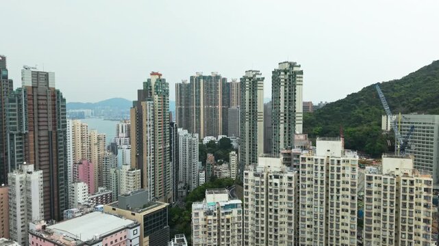 Dense Urban Landscape Of Hong Kong Revealing Towering Residential Buildings And Skyscrapers. Urban Sprawl Showing Crowded Residential Buildings. Architectural Complexity And Population Density From An