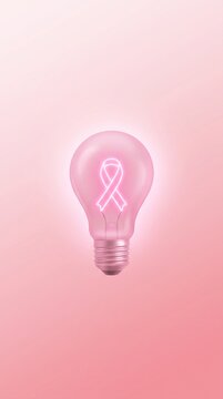 Breast cancer awareness conceptual glowing pink light bulb with ribbon symbol inside on pink gradient background for medical health campaign event