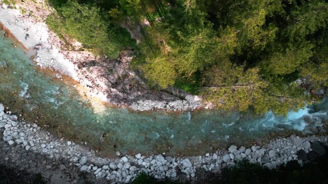 Scenic video of a crystal-clear turquoise mountain river Triglavska Bistrica flowing through a lush forest in the Peričnik area of Slovenia