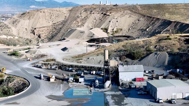 Lehi, Utah, United States - 21 August 2026: Aerial view of the Staker Parson Point West aggregate pit and ready-mix concrete plant with gravel piles and trucks.