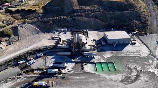 Lehi, Utah, United States - 21 August 2026: Aerial view of the Staker Parson Point West aggregate pit and ready-mix concrete plant featuring storage silos and settling ponds.