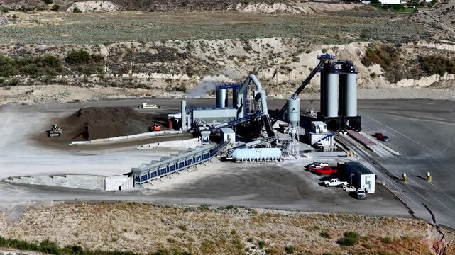 Lehi, Utah, United States - 21 August 2026: Aerial view of the Staker and Parson Point West aggregate pit and ready-mix concrete plant with industrial silos and conveyor belts.