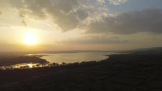 Nakuru, Kenya - 21 August 2026: Aerial view of Lake Elementaita at sunset with golden light reflecting on the water surface and surrounding savanna landscape.