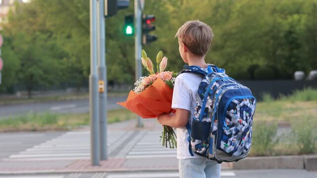Cute blond child, boy with bouquet on first school day in Czech Republic