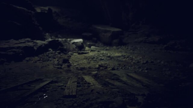 Dim ritual chamber floor illuminated by candle glow, circular arrangement of scorched stones and faint carvings, damp walls and incense haze suggest long