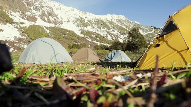 Adventure Camping site with tents Against Snow Covered Himalayan Mountains