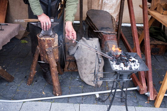 Medieval Blacksmith Working with Hot Iron at Outdoor Forge