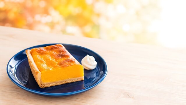 かぼちゃのタルト 藍色の皿に盛った秋の焼き菓子とコピースペース