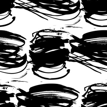Seamless pattern from figured textured black strokes on white paper