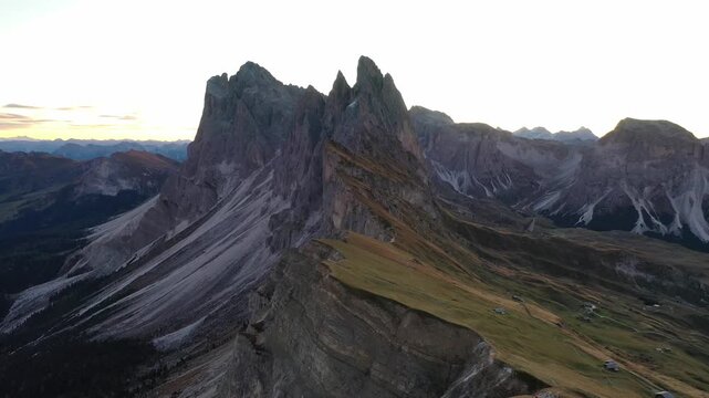 Aerial view of Seceda mountain ridge in Dolomites during golden hour sunrise.