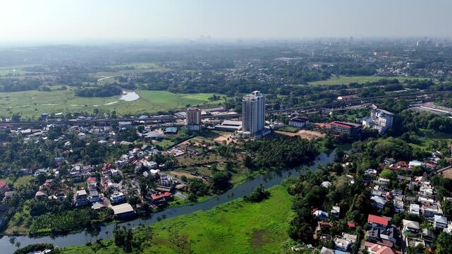 Aerial view of urban cityscape with river flowing through green landscapes in Kochi Kerala.