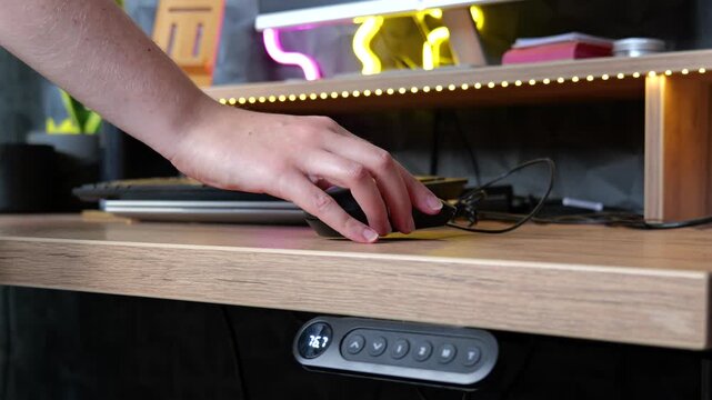 Person preparing home office desk and laptop for the workday