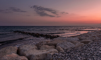 Obraz premium View of Pervolia village sea coast, beach and sea, after sunset, Larnaca district, Cyprus