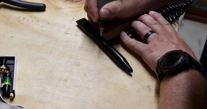 DIY Project Assembly, Close-up of hands working on a project with tools, demonstrating precision and focus during assembly
