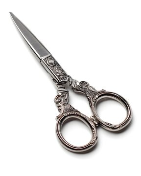 Intricately detailed metallic scissors with polished finish, stationery and craft tool isolated on white background