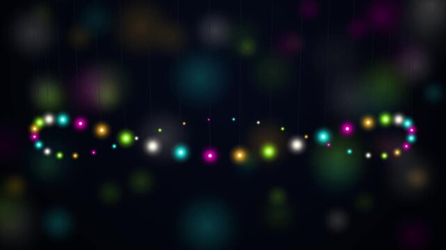 Festive string lights dance and shimmer in a dark, blurry bokeh background creating a magical, celebratory mood for holidays or events.