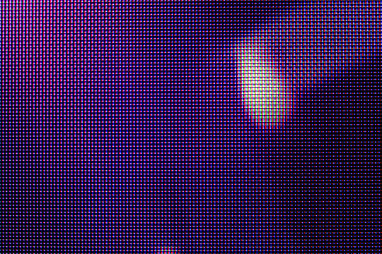 Purple LED display pixels macro photograph with soft light glare lens flare reflection and abstract