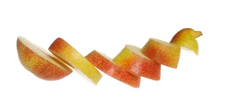 Sliced pear fruits flying isolated on white background, with clipping path