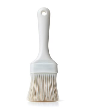 White silicone basting brush with flexible bristles, kitchen utensil isolated on white background