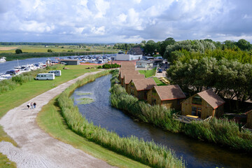 Naklejka premium Aerial View of Riverside Wooden Cabins and Marina Harbor