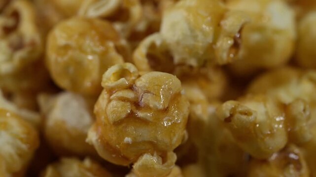 Golden caramel popcorn in close up, sweet crunchy popcorn pieces with rich caramel coating