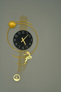 Gold ornate wall clock with pendulum and Roman numerals in elegant vintage design
