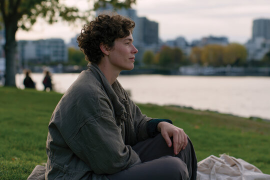 A serene figure enjoys a moment of peace in an urban park surrounded by nature, embodying the balance of city life and tranquility amidst the hustle and bustle.