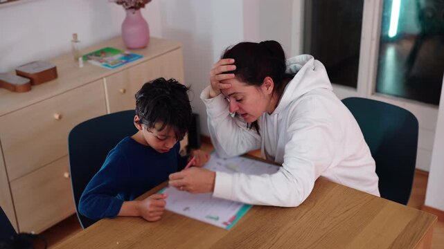 Parent helps child correct homework with a pencil at dining table at home, providing patient instruction, problem-solving guidance, encouragement and educational support