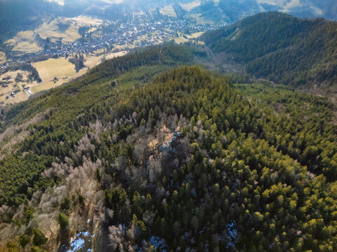Aerial view of the village of Lubietova nestled in the forested landscape of the Banska Bystrica Region, Slovakia.