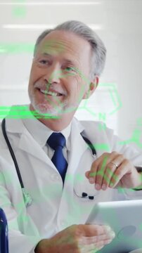 Animation of data processing on caucasian male doctor on wheelchair using tablet at hospital